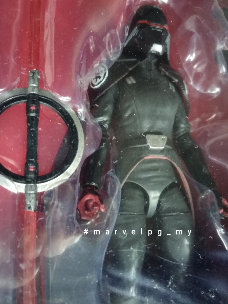 Black box with black suites armoured suit figure with face covered and round handled double blade sword on red card
